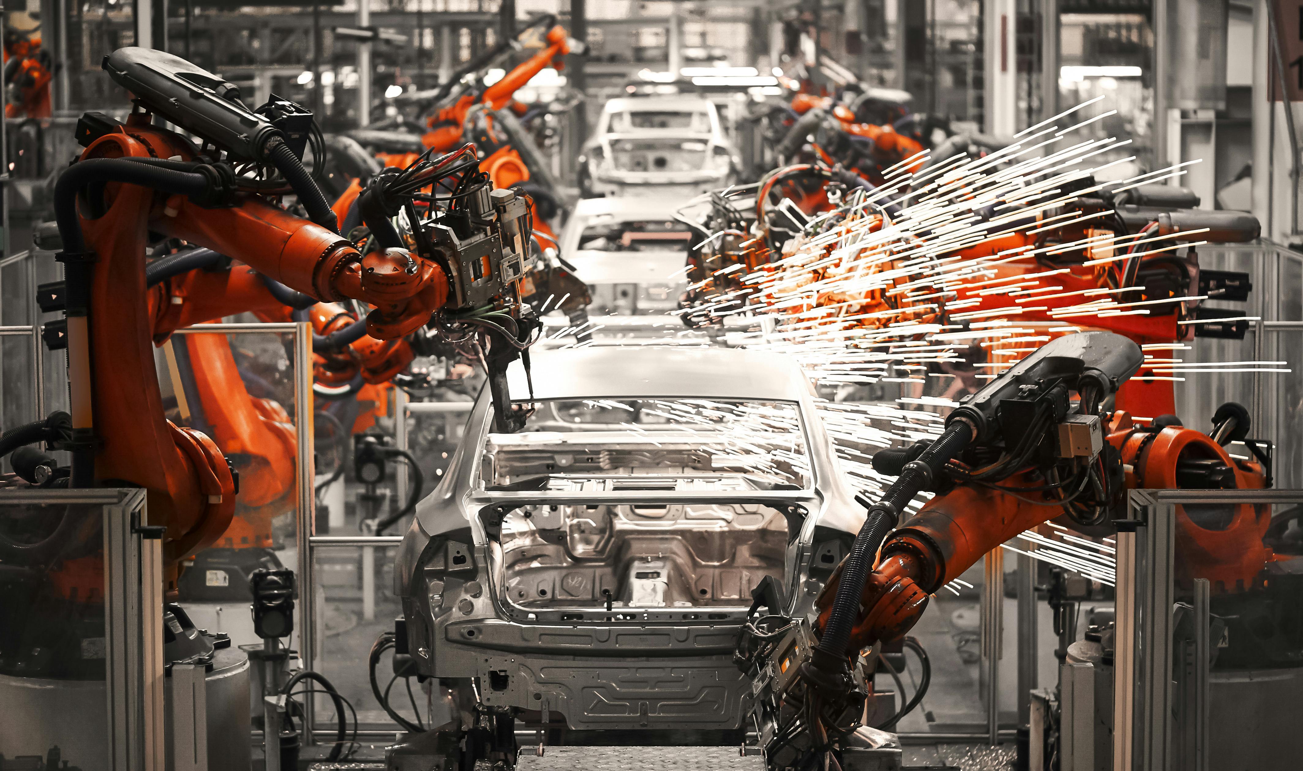 inside a automobile factory with robotic arms