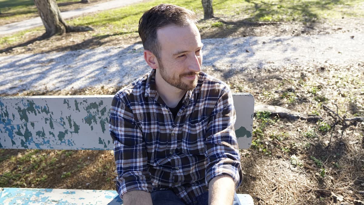 Man sitting on bench and smiling