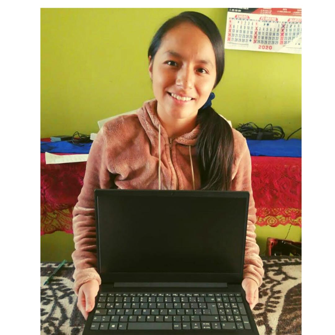 Olga, a HOPE scholar, with a laptop that has served as a tool to help her succeed, purchased with Help Them Hope’s support